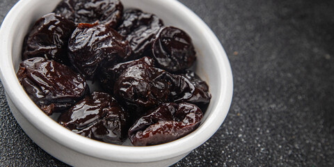 Dried prunes smoked drained plum gourmet food background on the table rustic food top view copy space keto and paleo diet vegetarian and vegan food