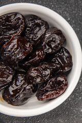 Dried prunes smoked drained plum gourmet food background on the table rustic food top view copy...