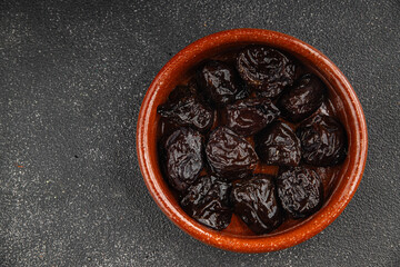 Dried prunes smoked drained plum gourmet food background on the table rustic food top view copy space keto and paleo diet vegetarian and vegan food