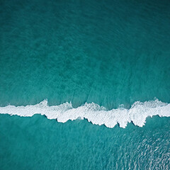 Aerial view beautiful of sea waves from drone. Stock image of blue color of ocean water, sea surface. Top view on turquoise waves, clear water surface texture.

