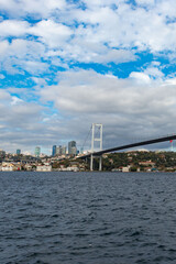 Istanbul Bosphorus Bridge or 15th July Martyrs Bridge with Istanbul panorama cityscape during summer sunny day. Istanbul, Turkiye