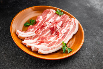 Bacon slices pork meat fresh gourmet food background on the table rustic food top view copy space