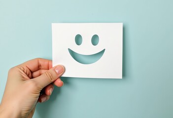 Mental Health Matters: Raise Awareness with a Hand Holding a Paper Cut Smile Face, Encouraging Positive Thinking, Assessment & Support on World Mental Health Day.

