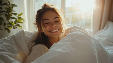 Happy woman waking up in bed, enjoying cozy morning light