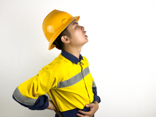 asian engineer wearing yellow helmet feeling back pain on white background