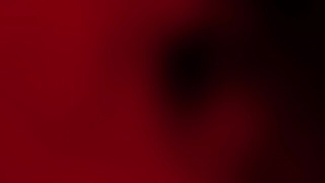 Abstract gradient background with smooth motion texture blending deep red and black shades, creating a visually striking effect for creative projects.