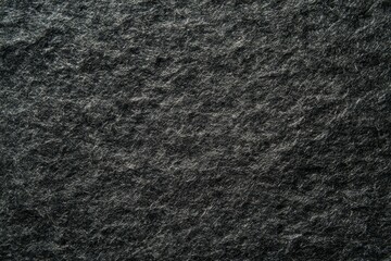 Dark textured stone surface with subtle light play. Neural network AI generated