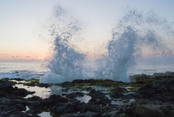 waves on a rocky beach Hawaii sunrise