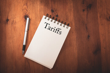 notebook with the words with the word Tariffs ,concept of trade tariffs ,economy , politics and government