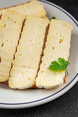 Sandwich soft cheese Camembert or Brie fresh delicious gourmet food background on the table rustic food top view copy space
