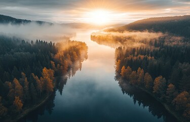 Aerially, sunlight dances on the lake, which is shrouded in morning mist