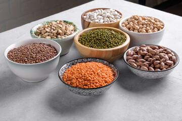 Nutrient-rich legumes for vegetarian cooking in the bowls on the table