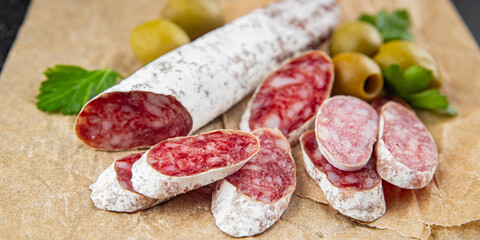 Fuet sausage Spanish meat delicacy fresh gourmet food background on the table rustic food top view copy space