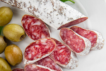 Fuet sausage Spanish meat delicacy fresh gourmet food background on the table rustic food top view...
