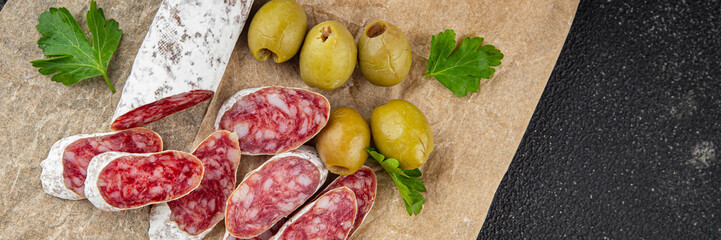 Fuet sausage Spanish meat delicacy fresh gourmet food background on the table rustic food top view copy space