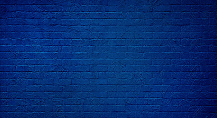a clean, textured blue plaster brick wall provides a neutral and versatile background for various design purposes. abstract weathered texture stained old stucco dark blue brick wall background.