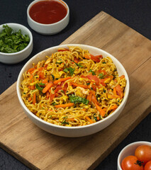 Bowl of noodles isolated on black table background.