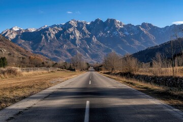 Fototapeta premium Mountain Road Extends into a Majestic Landscape
