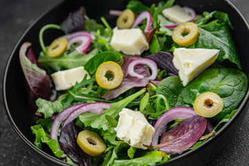 Salad olives, cheese and green leaves fresh gourmet food background on the table rustic food top view copy space vegetarian  food