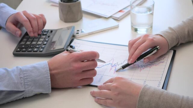 Young accountants, working together to prepare a financial report. Close-up. Slow motion.