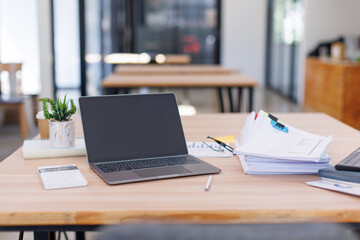 Close up Business Female using calculator and laptop for do math finance on wooden desk, tax, accounting, statistics and analytical research concept	
