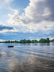 Man is fishing in a lake with a boat