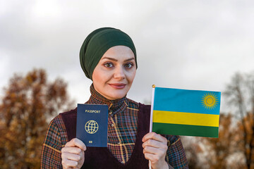Muslim Woman Holding Passport and Flag of Rwanda
