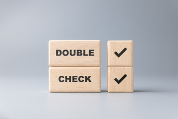 Double Check concept by stack wood blocks, verify information to prevent errors
