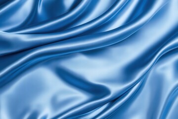 Obraz premium A smooth, flowing fabric in a rich blue color, showcasing elegant folds and a shiny texture that reflects light beautifully.