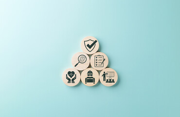 Work safety and compliance concept. Wooden blocks safety-related icons, including compliance,...