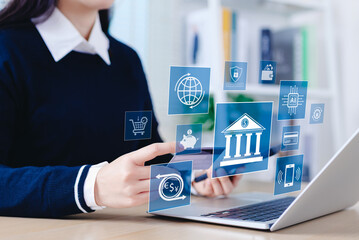 Digital banking and financial technology concept. Woman using laptop and smartphone with banking and financial technology icons, representing online bank, fintech, transactions, and secure payments.