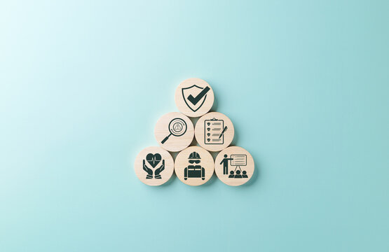 Work safety and compliance concept. Wooden blocks safety-related icons, including compliance, health, inspection, training, protection, regulatory, workplace safety, and risk management. Safety first,