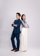 Full body image of young asian business couple posing on white background