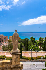 Fototapeta premium View of the statue of Caesar Augustus from behind the National Archaeological Museum in Tarragona with Mediterranean Balearic sea on a sunny day in summer, Catalonia, Spain