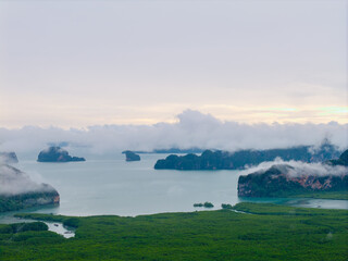 Aerial view Hong green lush tropical island and Phang Nga bay with fog, melancholic and mysterious...