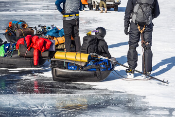 Lake Baikal. Group of tourists sitting at rest after a long day of skating on the ice of Lake...