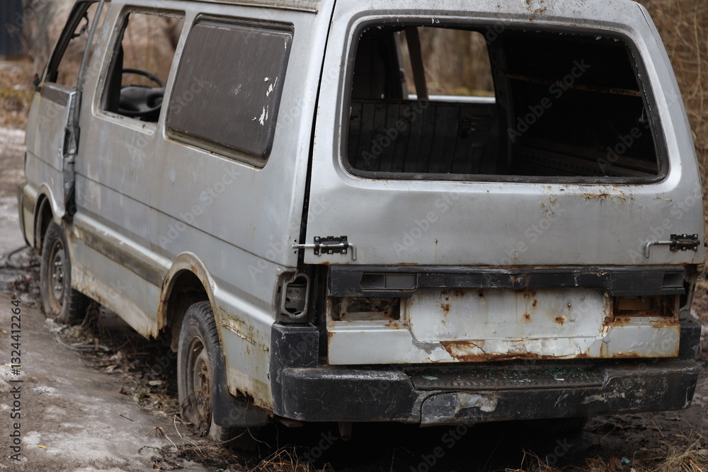 Poster a rugged 4x4 vehicle stuck in muddy terrain, suitable for use as a background or prop in outdoor sce
