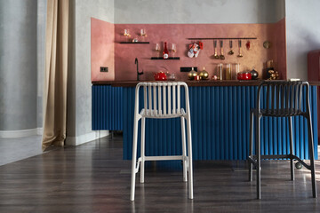 Naklejka premium Beautiful kitchens in blue tones, interior design and home improvement, classic kitchen cabinets, countertops with bar stools. There is a place to copy. High quality photo