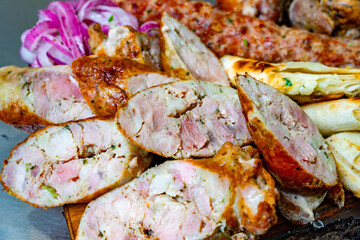 Grilled sausages served with fresh vegetables at a summer market
