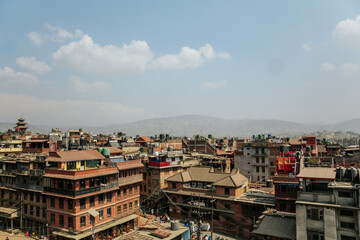 Cityscape of Kathmandu, the capital of Nepal, with mountains in the background and smog