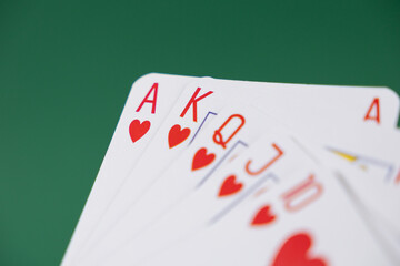 royal flush in hearts suit on a green background, perfect image for casino promotions, poker...