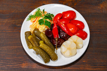 Colorful assortment of pickled vegetables on a white plate