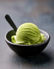 Matcha Delight: A close-up shot showcases a single scoop of vibrant green matcha ice cream nestled in a stylish, dark bowl, tempting the viewer with its refreshing allure.