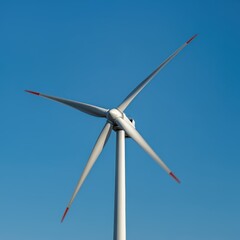 A hovering wind turbine propeller blade against a clear sky blue background.