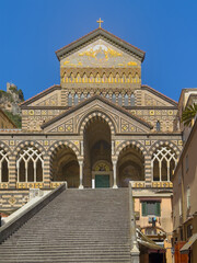 Obraz premium Amalfi, Salerno, Italy - July 6, 2024: Cathedral of St Andrew Apostle front facade with long stairway leading to entrance. 