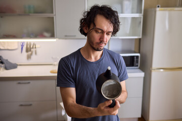 Unboxing a stylish, modern black kettle designed for use in a bright, contemporary kitchen space