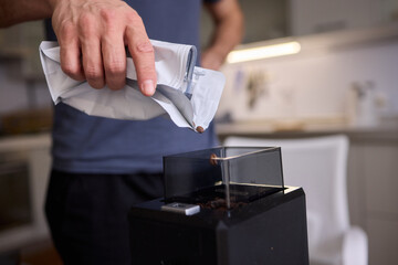 Pouring Coffee Beans into a Container for your brewing process each morning is essential