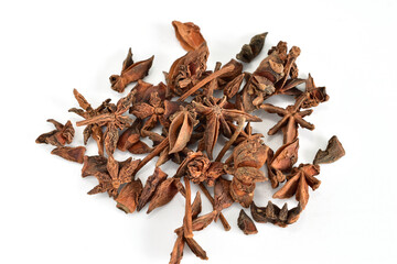 Broken star anise or aniseed, aromatic spice for cooking on white background.