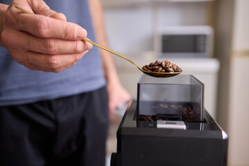 This is a Close Up of Coffee Beans Nestled in a Spoon, Perfectly Ready for Brewing Soon