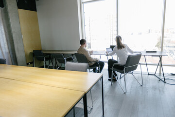 Two business office workers in office building